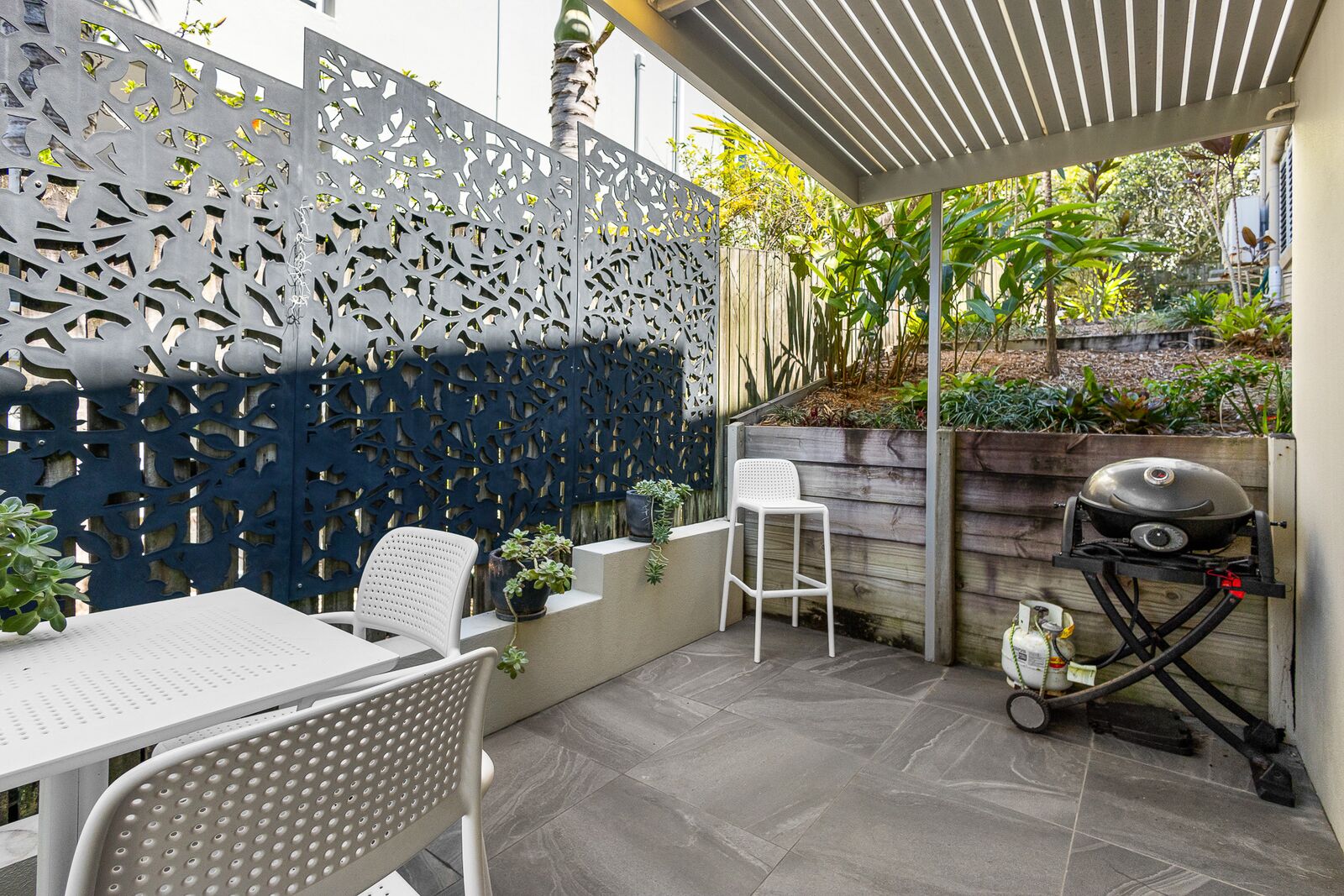 Unit 1 side courtyard with BBQ